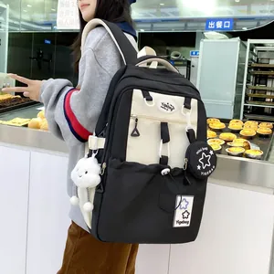 Detail of black and white high-capacity school backpack with plush star charm