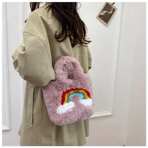 Detail view of pink plush bag with rainbow embroidery and gold chain strap