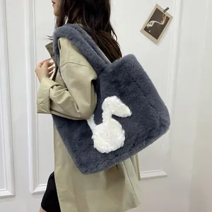 Detail of plush grey tote bag with soft faux fur texture and white rabbit embroidery