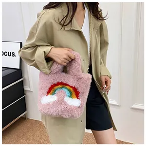 Detail of pink faux fur handbag with rainbow cloud embroidery and gold chain strap