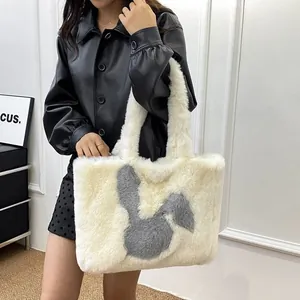 Detail of cute plush rabbit tote bag in cream white faux fur with grey bunny pattern