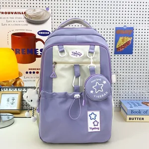 Detail of lavender and cream school backpack with plush charm in a cozy study setting