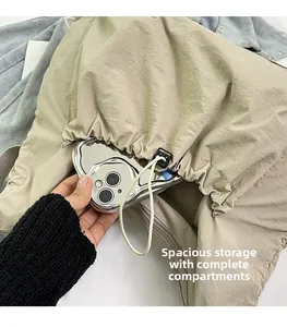 Detail view of khaki nylon dumpling bag showing spacious storage for a phone