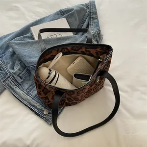 Interior view of leopard print tote bag showing storage of umbrella and wallet