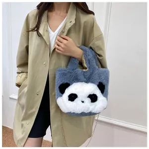 Detail of cute plush panda handbag featuring soft grey faux fur and gold chain strap