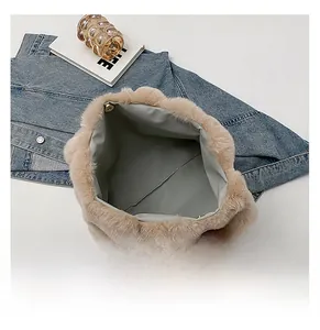 Detailed interior of plush shoulder bag with magnetic snap and soft faux fur edges