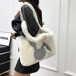 Detail shot of a large fluffy white plush tote bag with grey bunny motif on model