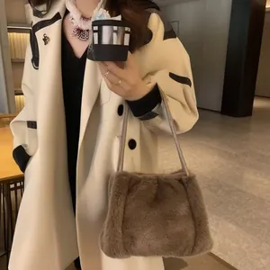 Brown faux fur shoulder bag worn with cream coat showing its plush texture and stylish fit