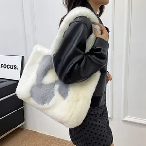 Model wearing a large white faux fur tote bag with H-pattern, showing casual style and size
