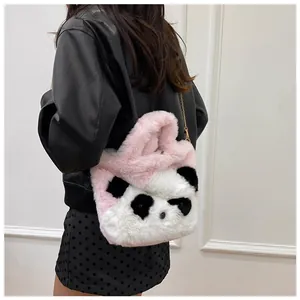 Detailed view of pink and white plush panda bag with gold chain strap on a model