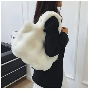 Plush white faux fur tote bag shown in a stylish autumn winter outfit context