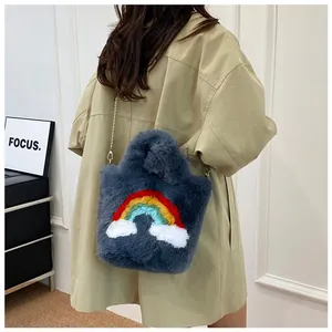 Detail of plush crossbody bag with rainbow cloud design and golden chain strap