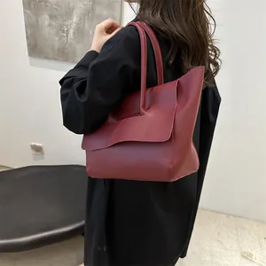 Minimalist burgundy leather tote bag with large fold-over flap for women's daily commute