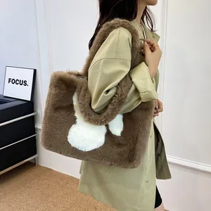 Detail of dark brown plush tote bag with white rabbit applique and thick furry strap