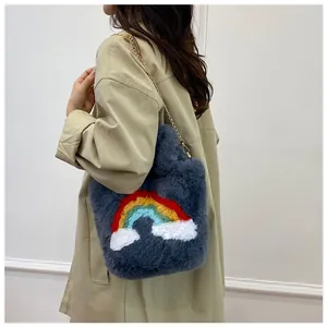 Detail of grey plush tote bag with colorful rainbow pattern and gold chain strap