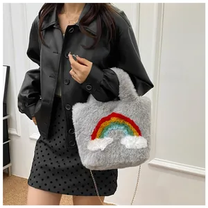 Detailed shot of a plush crossbody bag featuring a rainbow patch and gold chain strap