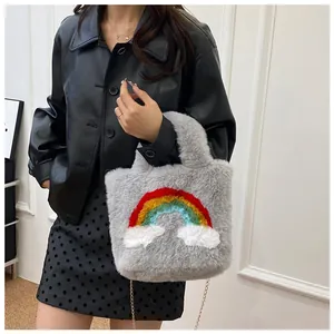 Detail of plush grey handbag with rainbow embroidery and golden metal chain strap