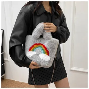 Close-up of gray plush handbag featuring a colorful rainbow design and golden metal chain