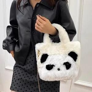 Cute panda plush handbag with metallic chain strap worn by a model in black outfit
