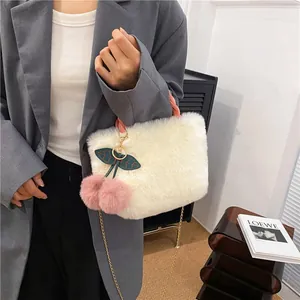 Winter plush handbag with pink handles and 3D cherry charms for women in daily casual setting
