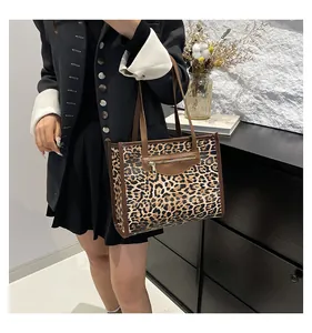 Detail of vintage leopard print tote bag featuring a decorative front zipper pocket