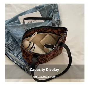 Interior capacity show of leopard print tote bag holding umbrella, wallet, and phone