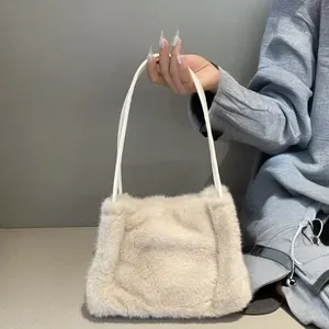 Detail of soft beige faux fur tote bag showing the plush texture and thin shoulder strap