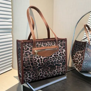 Vintage leopard print tote bag with brown handles and a gold-tone front zipper pocket