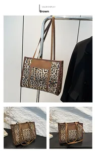 Detail view of the brown leopard print tote bag with premium leather handles and trim