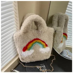 Detail of plush tote with rainbow cloud patches and a gold metal chain strap