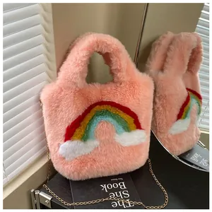 Detailed view of pink plush bag with rainbow embroidery and gold chain strap detail