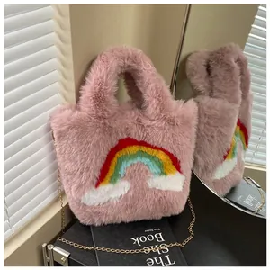 Detail of pink plush tote bag showing knitted rainbow decoration and gold chain strap