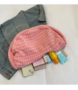 Detailed interior of a pink plush dumpling bag showing large capacity for essentials