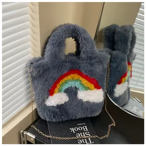 Detail view of grey faux fur bag with rainbow cloud design on a black display book
