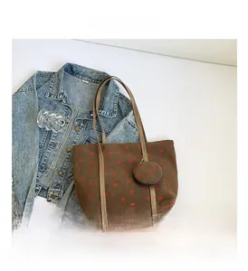 Detail of brown corduroy tote bag with red hearts and a matching round mini coin purse