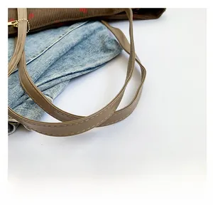 Detailed close-up of brown PU leather shoulder strap with precise double-row stitching