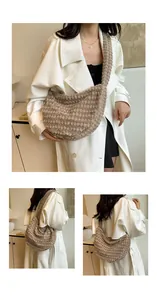 Detail of khaki plush crescent bag showing soft curly faux fur texture and wide shoulder strap