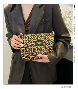 Close-up of leopard print makeup bag with zipper closure and fashion leather tag details
