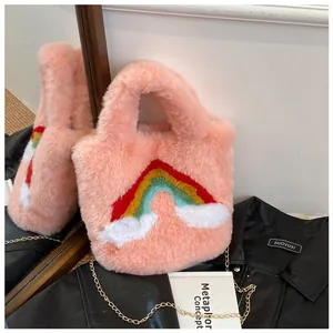 Detail of pink plush handbag with colorful rainbow embroidery and gold chain strap