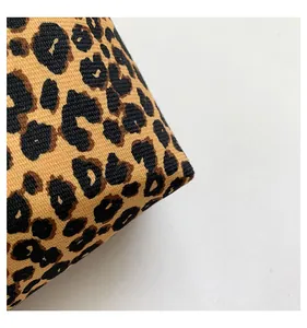 Close-up of durable leopard print canvas fabric texture and stitching on the bag