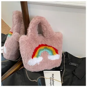 Detail of pink faux fur handbag with rainbow embroidery and gold chain strap accent