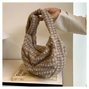 Detail of soft fleece hobo bag with beige and camel woven texture and zipper closure