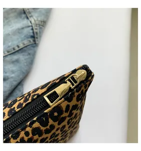 Close-up of high-quality golden metal zipper detail on leopard print makeup bag
