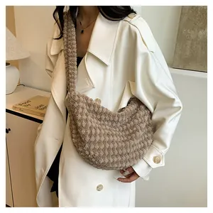Brown fluffy hobo bag with soft texture worn with a white coat for winter style