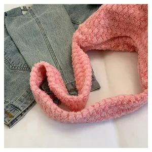 Close-up of pink faux fur shoulder bag with soft plush texture and wide strap detail