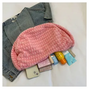 Pink sherpa crescent bag detail showing large capacity for daily makeup and essentials