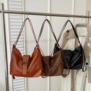 Vintage leather tote bag in three colors with decorative belt buckle and side zippers