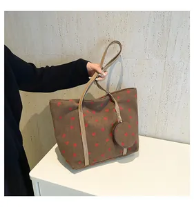 Brown corduroy tote bag with red strawberry embroidery and matching mini coin purse detail