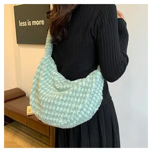 Detail of soft green faux shearling pleated shoulder bag on model for winter fashion
