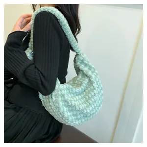 Detail of light green faux fur shoulder bag showing plush texture and puffy moon shape